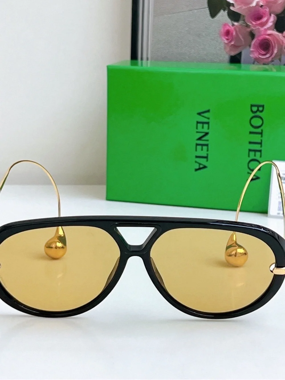 Bottega Veneta Black Frame Sunglasses with Amber Lenses and Gold Details